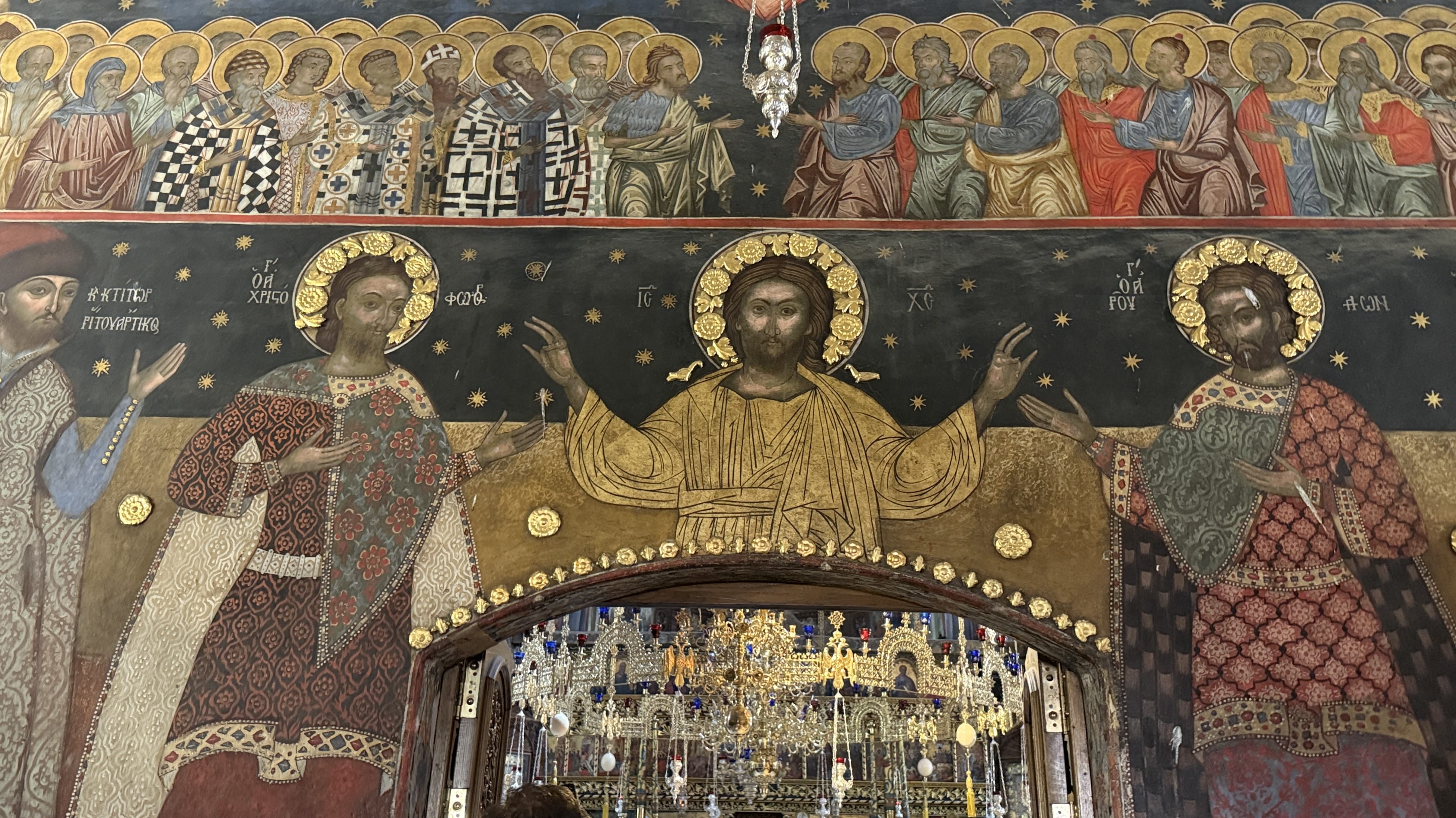 Frescoes of Christ and saints covering the walls above an arch inside Bachkovo Monastery in Bulgaria