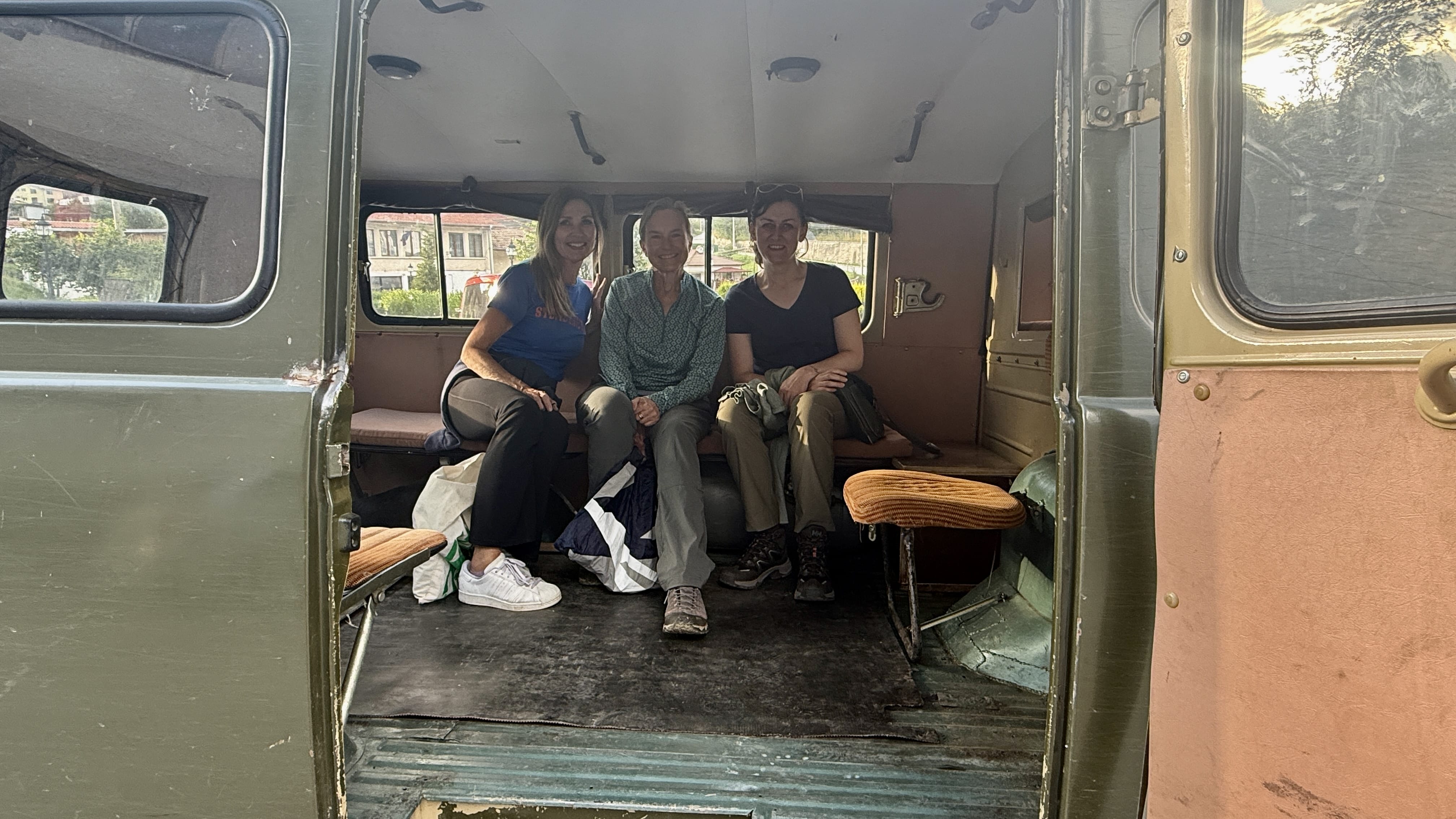 Three travelers sitting inside an old UAZ van before a bear-watching trip in Bulgaria